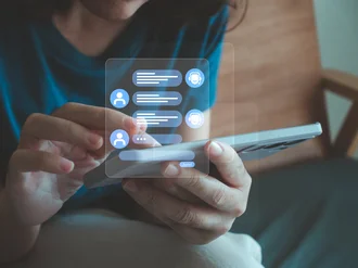 Person nutzt Smartphone mit virtueller Chat-Oberfläche, die Gespräche zwischen Nutzer und KI-Assistent zeigt – symbolisiert digitale Kommunikation, Mobile Messaging und künstliche Intelligenz im Alltag